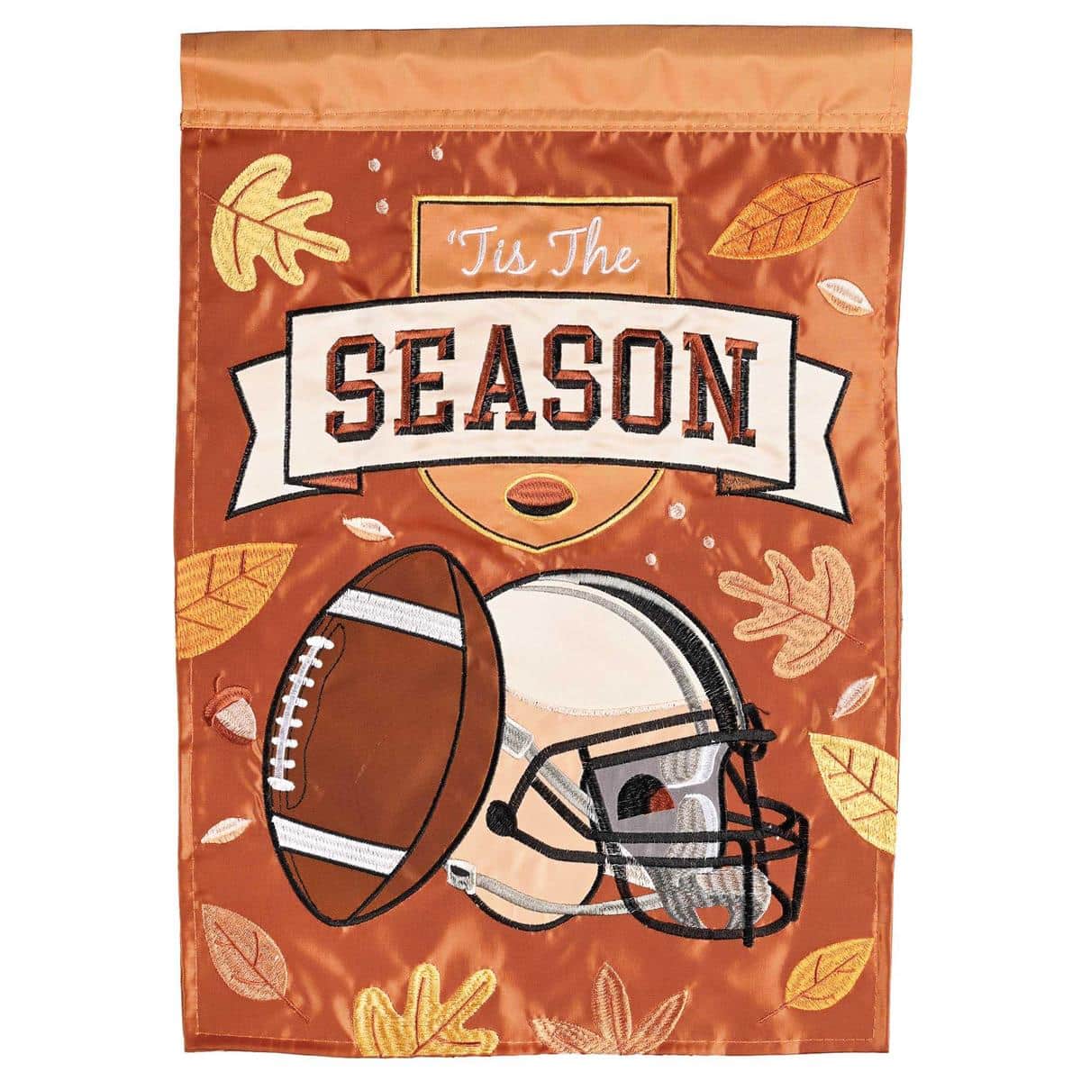 13 x 18 Football Tis The Season double applique garden flag with brown football, white laces, and bold script, hanging on a metal stand by a front path.