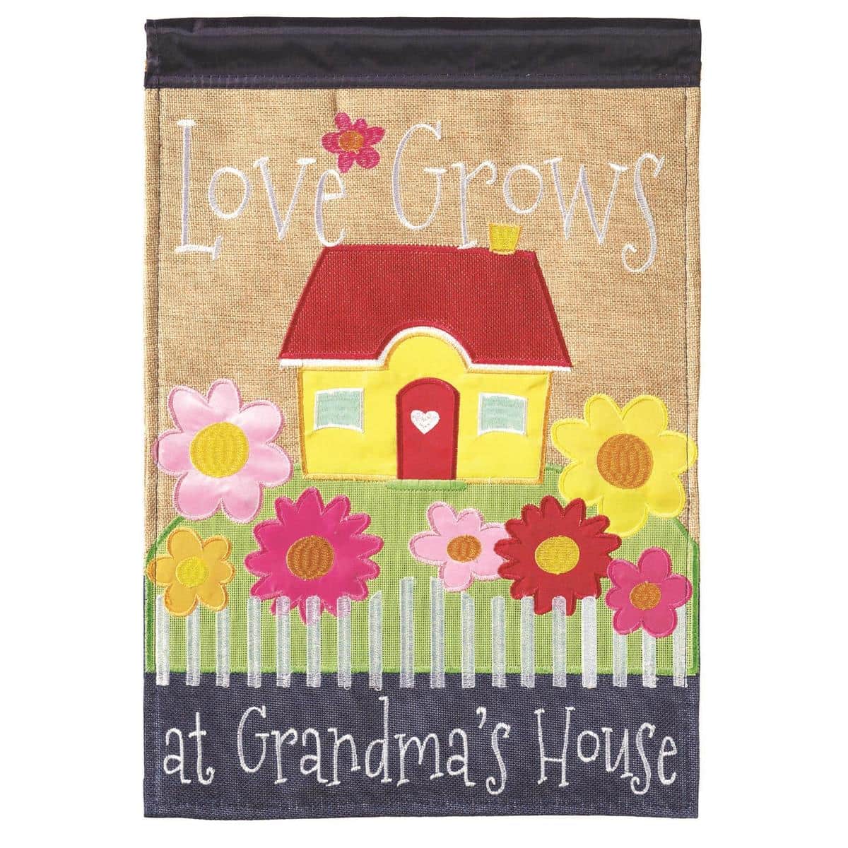 Front view of 13x18 Grandmas House Burlap Garden Flag with layered double applique lettering that reads Grandma's House, displayed on a garden pole against a porch backdrop showing rustic burlap texture and country style.