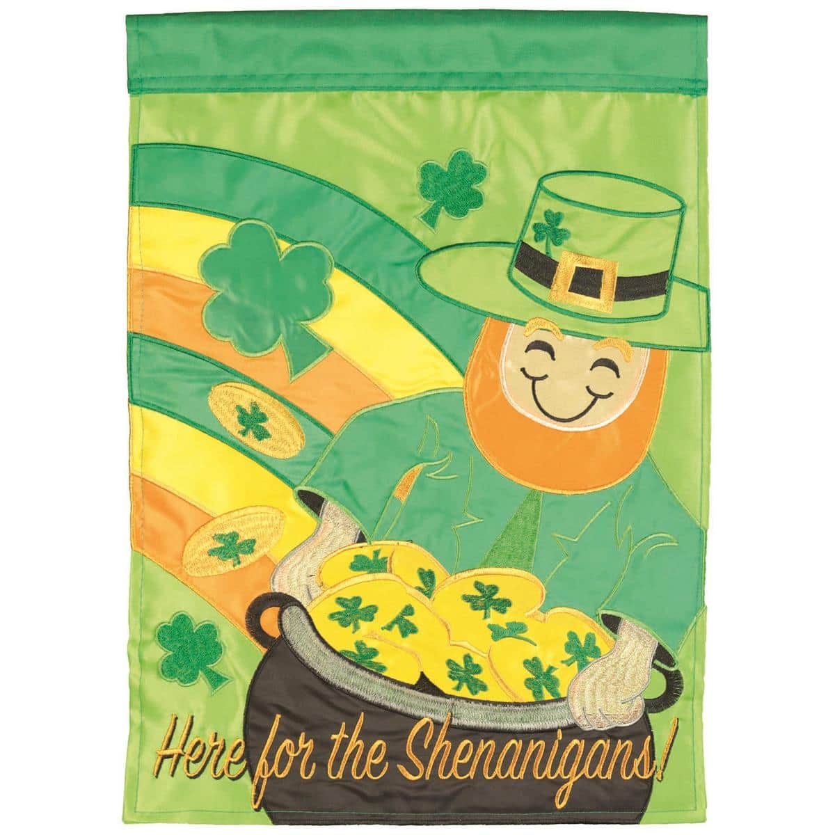 Green 13x18 double applique garden flag with the phrase "Here For The Shenanigans!" in bold lettering, accented by shamrocks and gold coin motifs, shown on a standard garden flag pole outdoors.