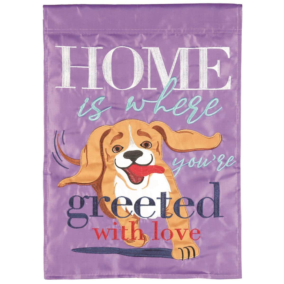 Double applique dog themed garden flag reading Home Is Where Youre Greeted, 13 x 18 inches, two sided, displayed outdoors on a stand by a front walkway.