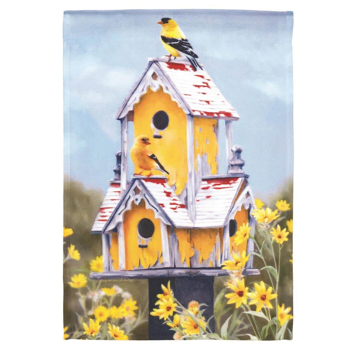 13x18 printed garden flag featuring colorful birds perched on a wooden birdhouse, shown mounted on a small yard pole in a front garden setting with green shrubs and a stone path, highlighting the detailed print quality and compact size of this durable outdoor flag.