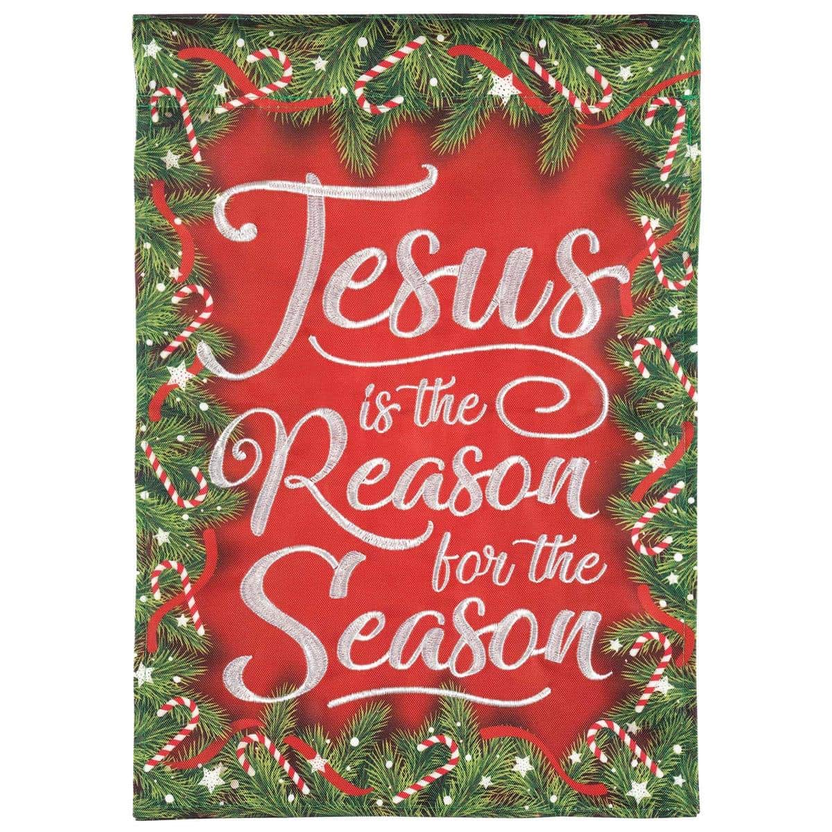 Outdoor house flag reading 'Jesus Is The Reason' with nativity star and evergreen accents in classic Christmas colors, double applique texture and reinforced sleeve visible