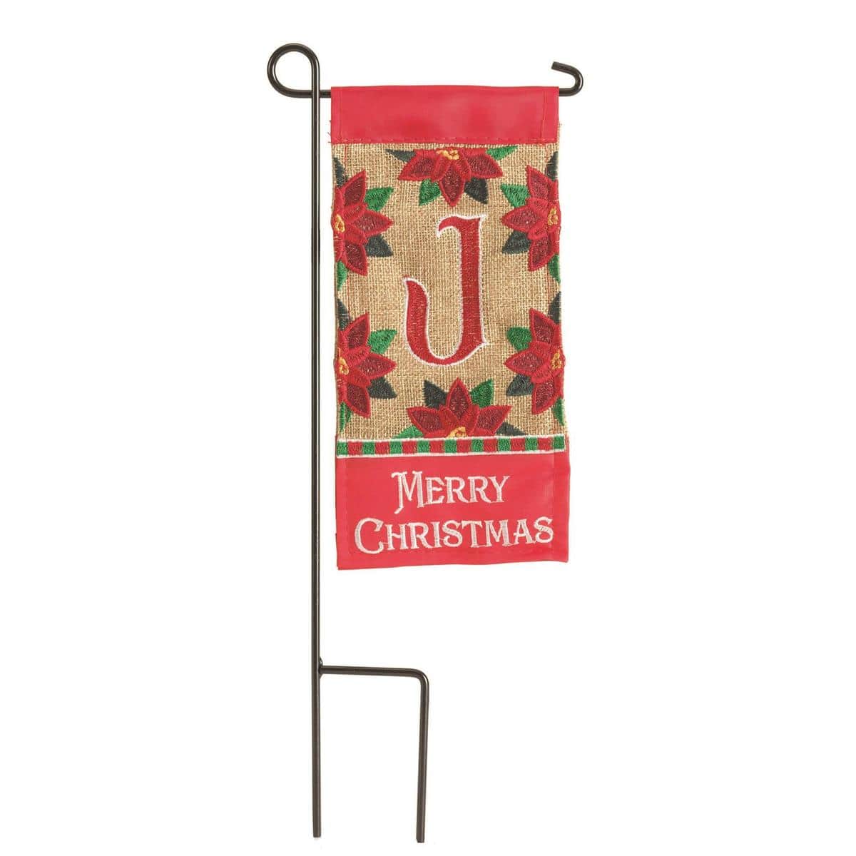 Mini 4x8 Christmas monogram flag featuring the letter J in a festive wreath-style frame, shown inserted on a small garden stake beside a planter with evergreen accents.