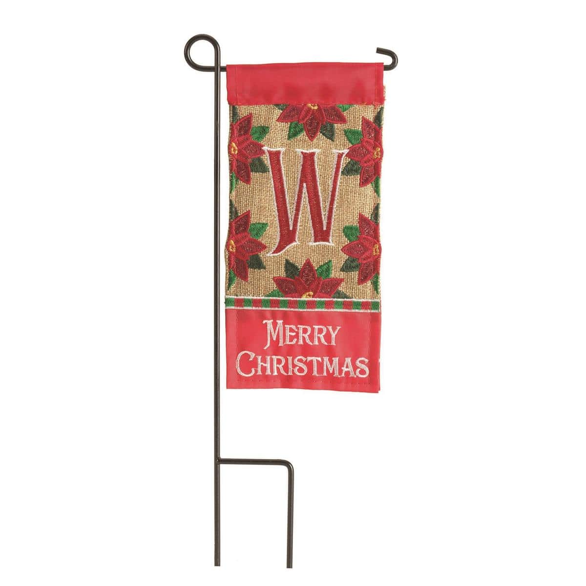 Close-up image of Mini Christmas Monogram-W 4x8 mini flag showing a bold W monogram in red and green with holly accents, photographed on a planter stake for small-space holiday display.