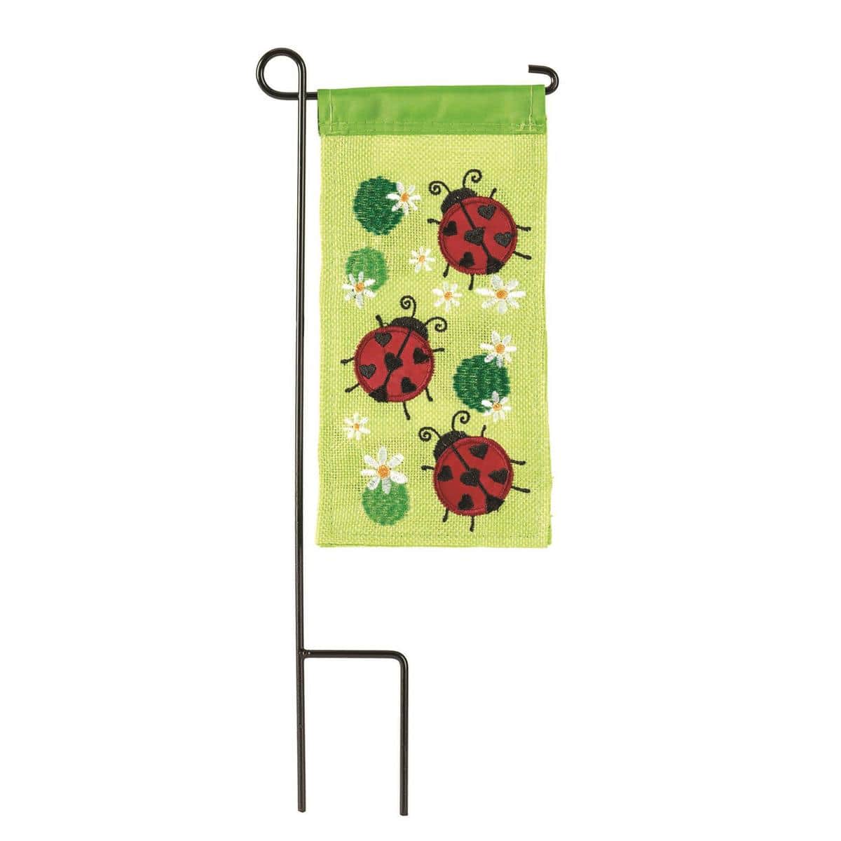 4x8 burlap mini flag with red ladybug artwork displayed in a planter, showing textured weave, stitched edges, and a slim sleeve for a mini pole