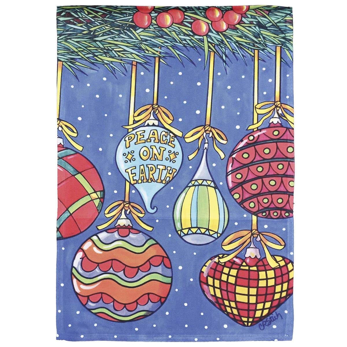 Round printed Peace On Earth ornament with dove motif and gold lettering on white background, hung by ribbon on a decorated Christmas tree branch.