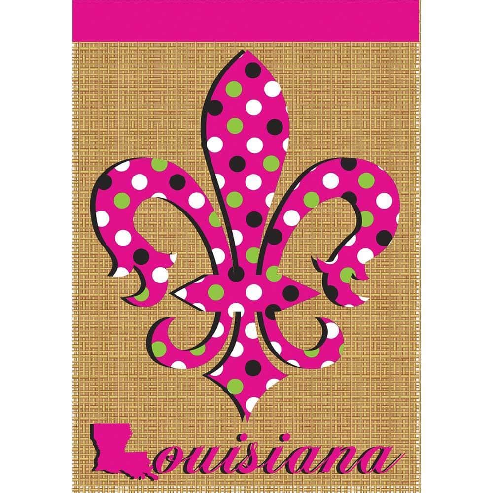 Main image of a 13x18 pink polka dot burlap garden flag showing layered double applique polka dots, stitched edges, and a rustic woven texture mounted on a standard garden flag pole in a leafy outdoor setting.