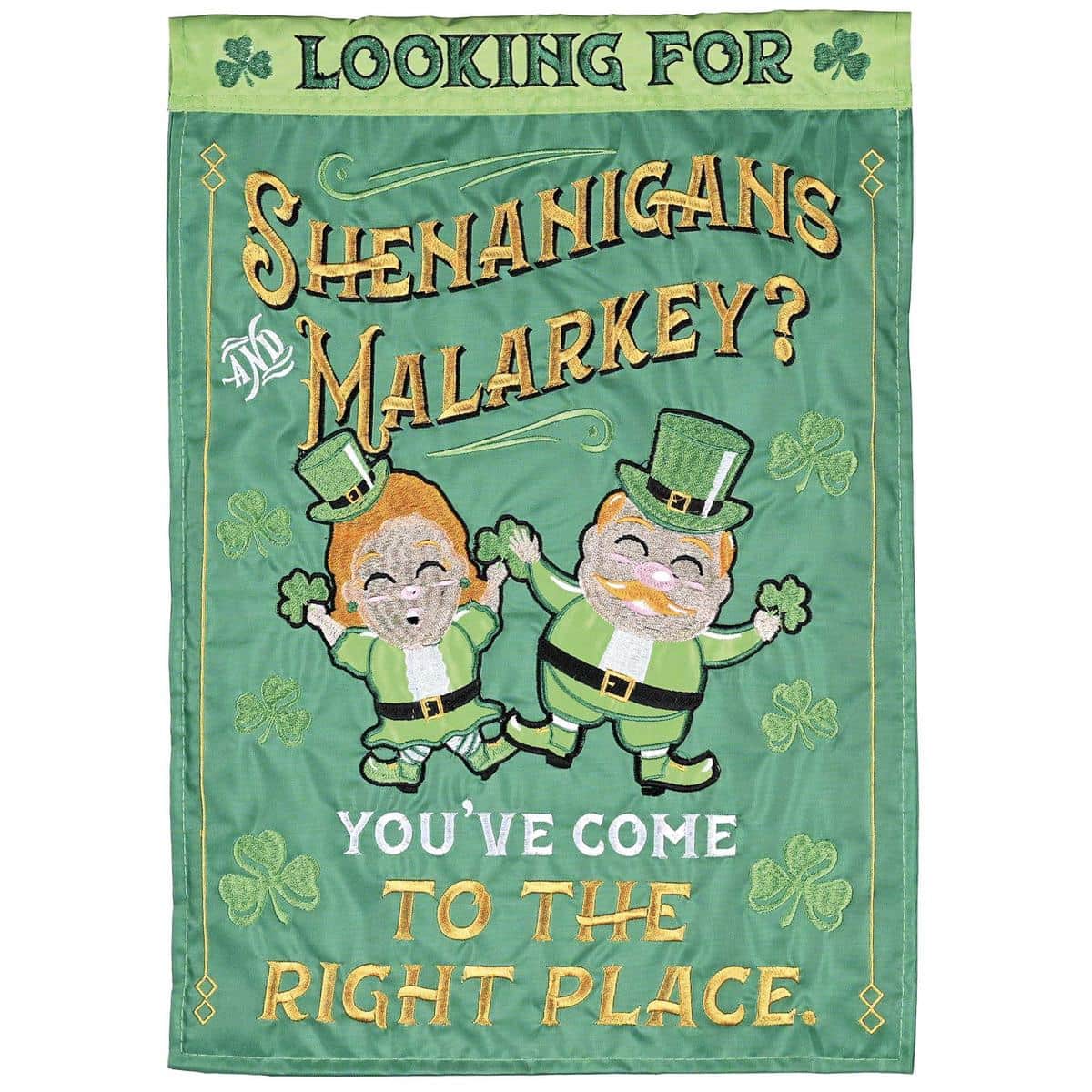 Main product image showing the Shenanigans And Malarkey? St. Patrick's double applique flag in vibrant green with raised applique lettering, shamrock accents, and a pole sleeve, displayed on a porch railing to highlight texture and outdoor styling.