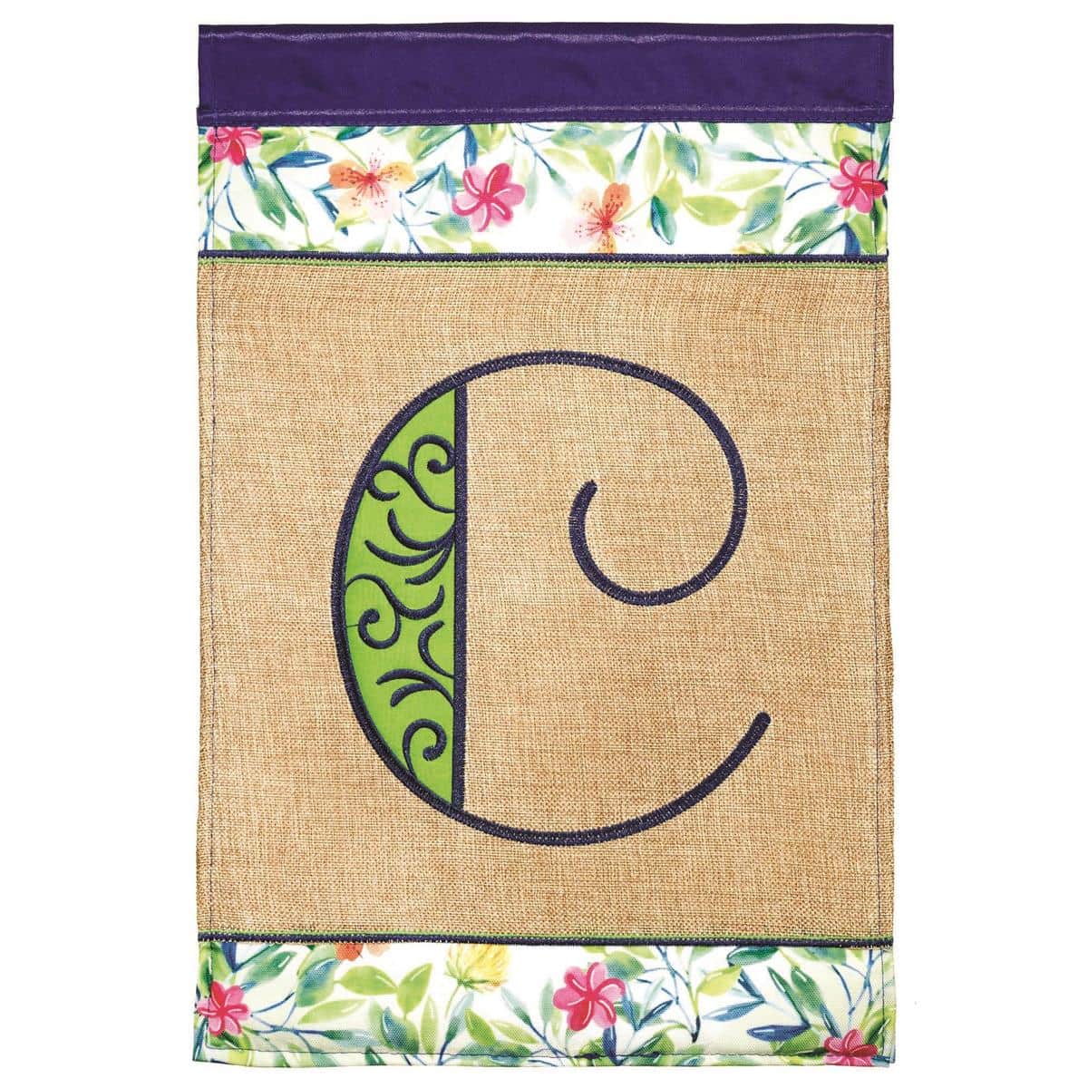 Close-up of 13x18 Spring Burlap Monogram C garden flag showing layered applique letter on natural burlap, top sleeve for standard stand, displayed by a blooming porch.