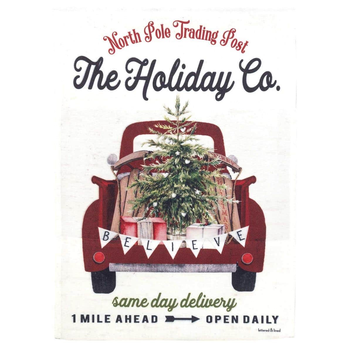 Vintage red truck carrying holiday greens printed on a 13x18 garden flag, shown on a porch flag holder with wreaths and string lights, closeup of printed detail and pole sleeve.