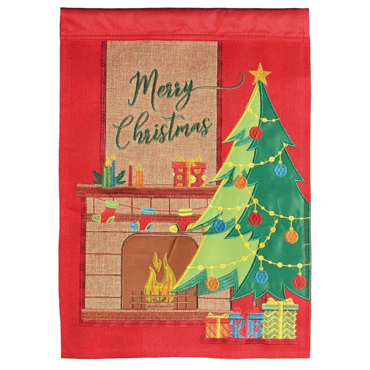 13x18 Tree MerryChristmas double applique garden flag with green Christmas tree, ornament accents, and "Merry Christmas" script displayed on a small yard pole beside seasonal greenery.