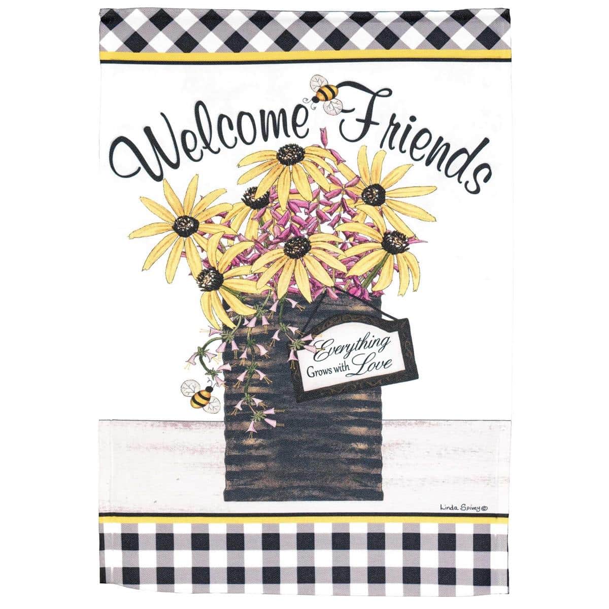 Close-up image of the Welcome Friends 13x18 printed floral garden flag with "Welcome Friends" lettering displayed on a black metal garden flag stand in a sunny front garden setting