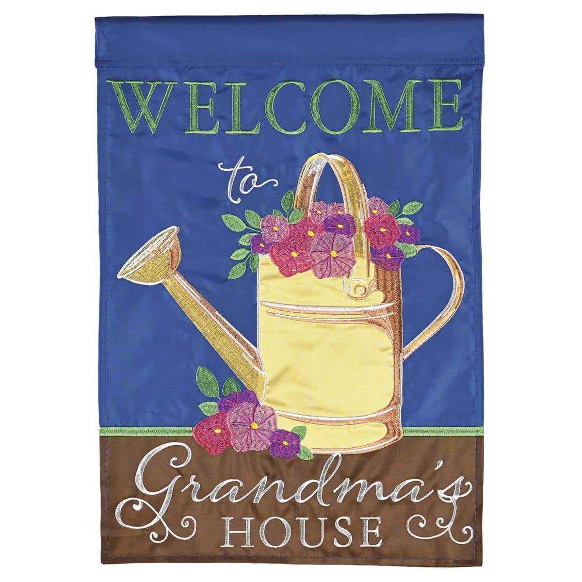 Close-up of a 13x18 Welcome To Grandmas House double applique garden flag with bold double-sided lettering and layered fabric, displayed on a stand outdoors.