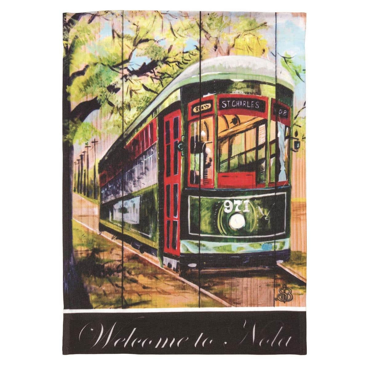 Alt text for main image: Printed 13x18 Welcome To NOLA garden flag in purple, green and gold with Louisiana motifs displayed on a yard flag stand in a garden setting
