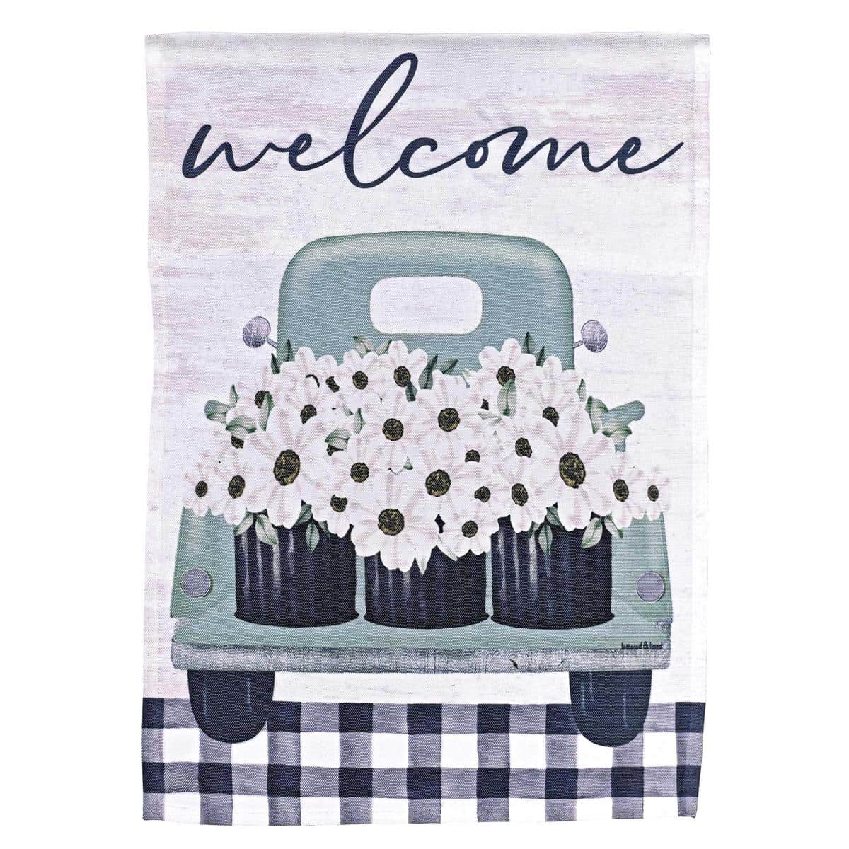 13x18 garden flag with a printed vintage pickup truck filled with colorful flowers and a prominent 'Welcome' message, displayed on a metal garden flag stand in a grassy border.