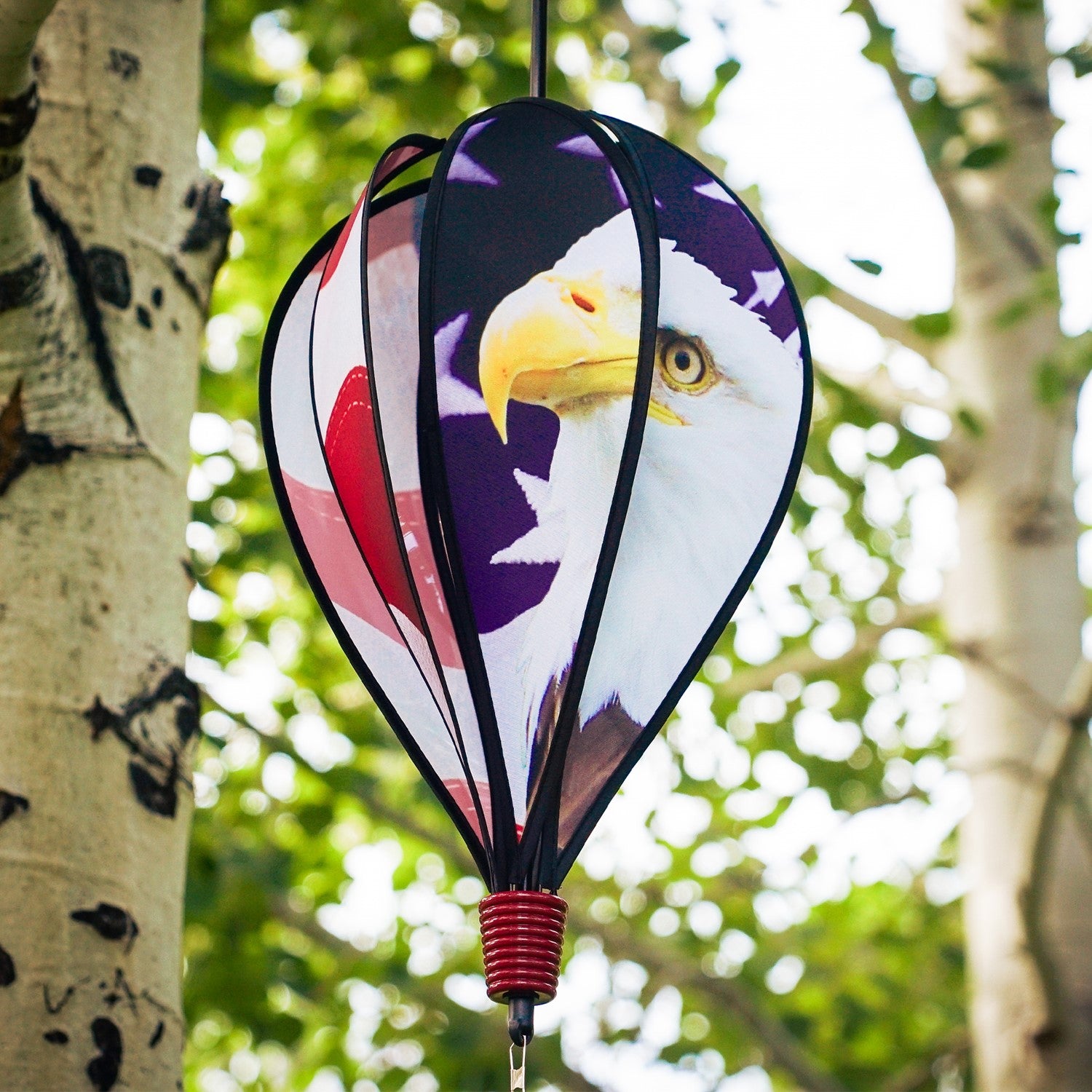 American Flag Eagle 6-Panel Hot Air Balloon displayed in a garden, showcasing vibrant colors of the American flag and a majestic bald eagle design.