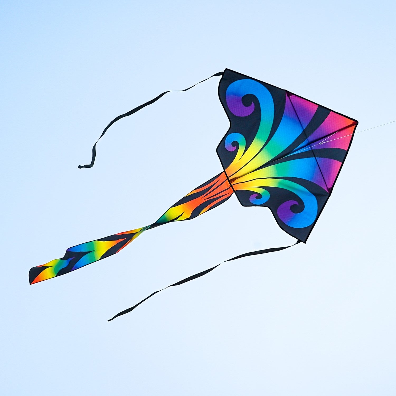 Aurora 46 inch Fly-Hi Kite soaring in a clear sky, featuring colorful printed design and streamer tails, ideal for family outdoor activities.