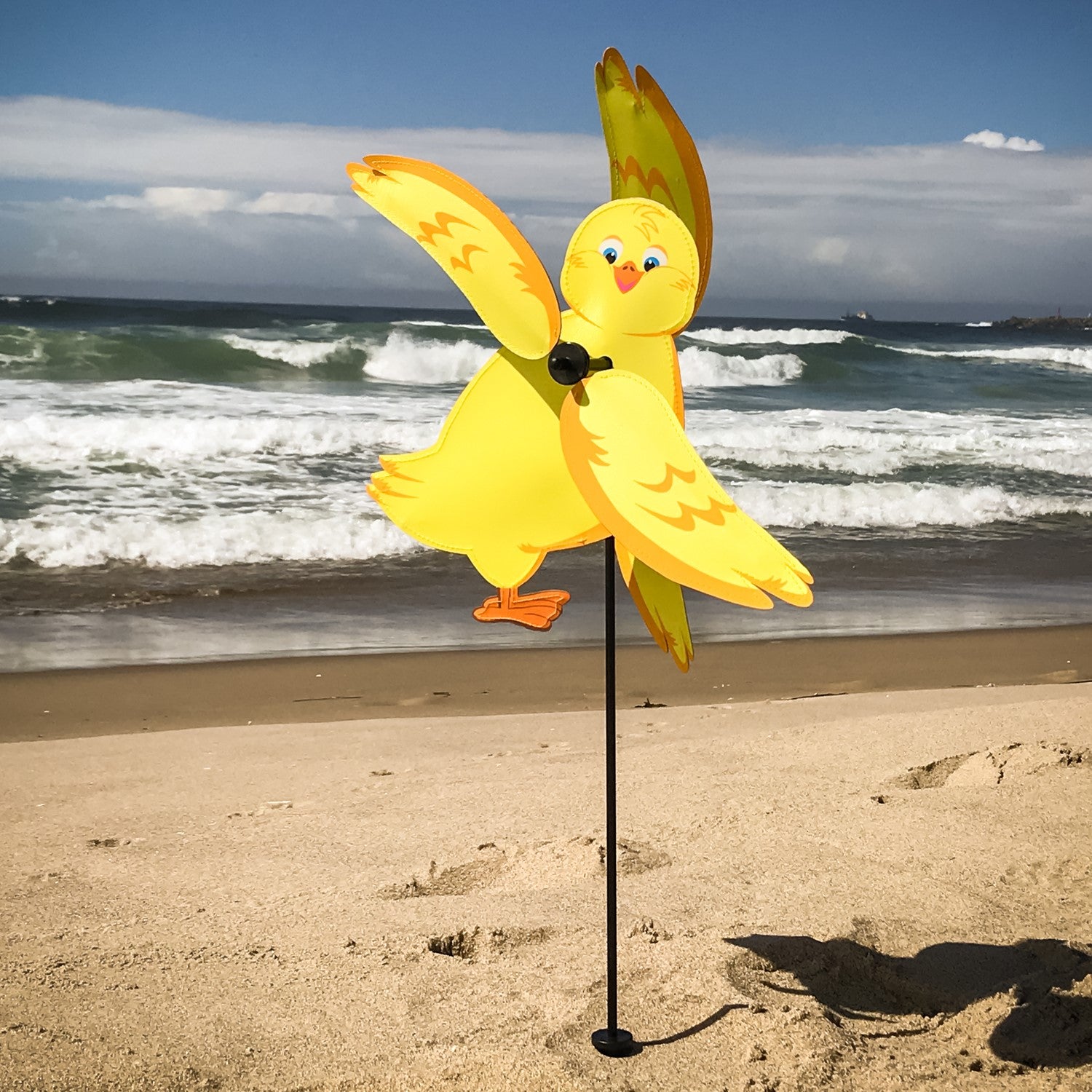 Baby Chick Whirligig featuring a cute yellow chick design spinning in the breeze in a garden setting, crafted from durable materials.