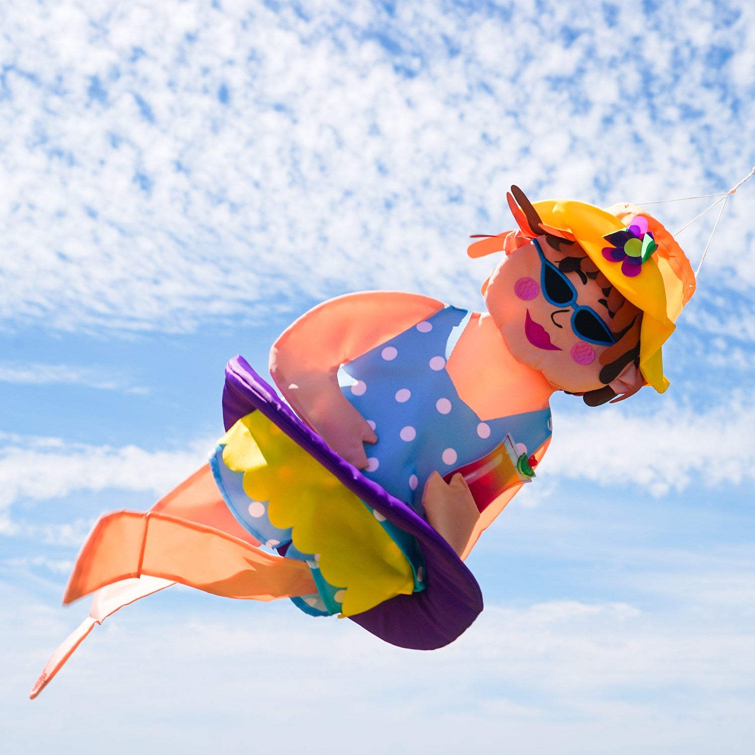 Beach Bev Wind Friend hanging decor featuring 3D design, vibrant colors, and embroidered accents, displayed outdoors in a garden setting.