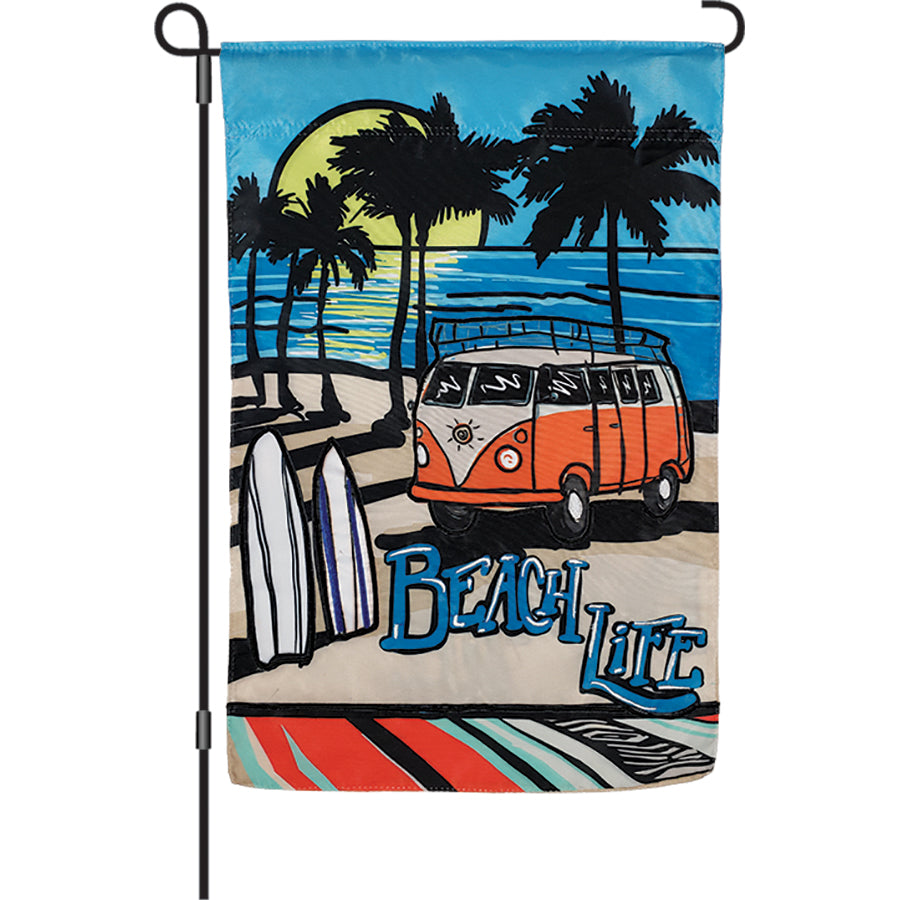12 in. Beach Life garden flag featuring a colorful van on a beach, displayed in a sunny outdoor setting, celebrating summer vibes.