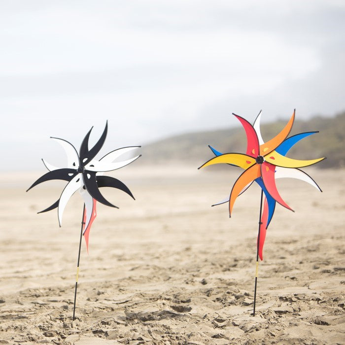 Black and White Spinning Jester with Rotating Windsail displayed in a garden, showcasing two 27-inch wheels and a fun design spinning in the wind.