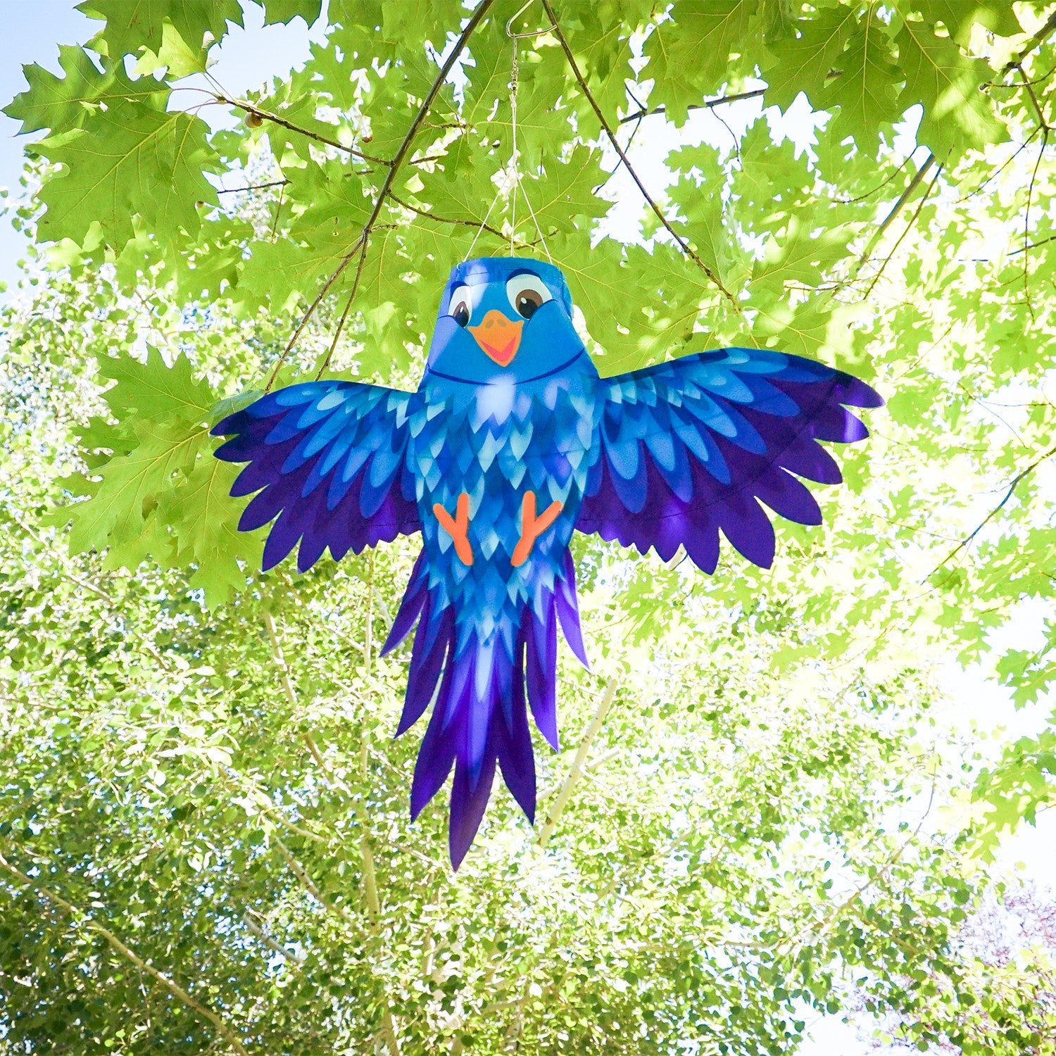 Colorful Blue Bird Windsock hanging from a pole, featuring spreading wings and vibrant design, swaying gently in the breeze.