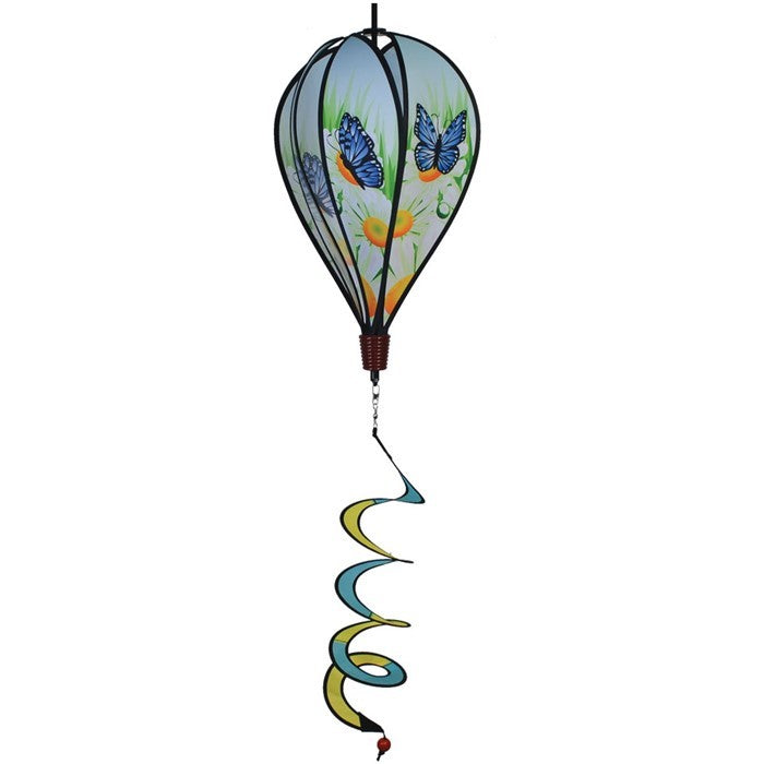 Colorful Blue Butterfly Hot Air Balloon spinner with butterfly design and daisies, displayed outdoors, showcasing movement in a garden setting.