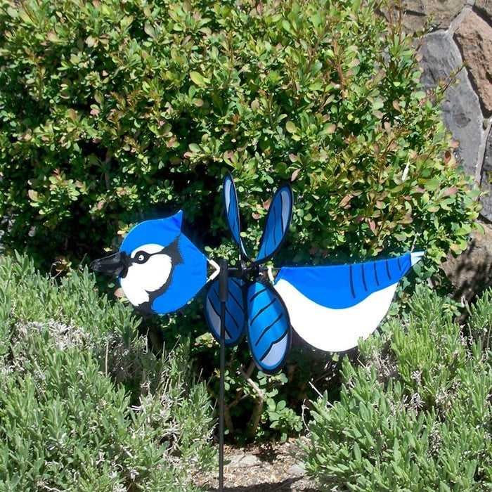 Blue Jay Baby Spinner vividly displayed in a garden setting, featuring colorful design and 12-inch spinning wheel for outdoor charm.