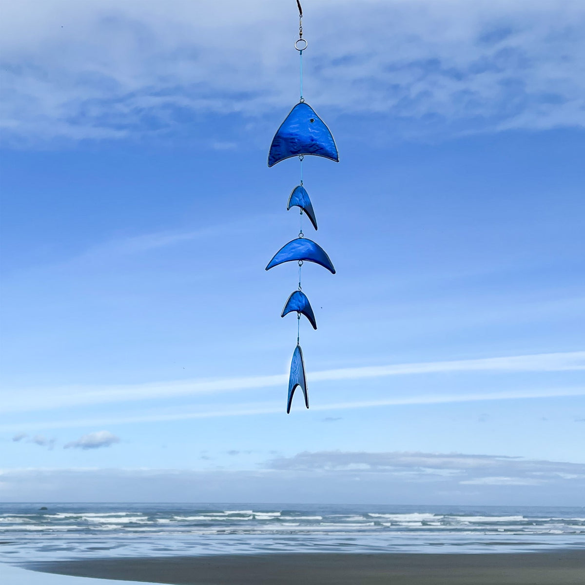 Blue Resin Fish Mobile featuring a blue gradient design, hanging decor with colored resin blocks, swaying gently in a sunlit outdoor setting.