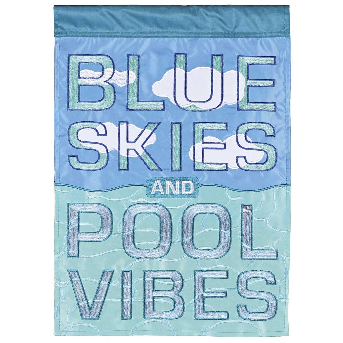 Blue Skies and Pool Vibes double-applique garden flag showcasing colorful summer designs with intricate embroidery in a garden setting.