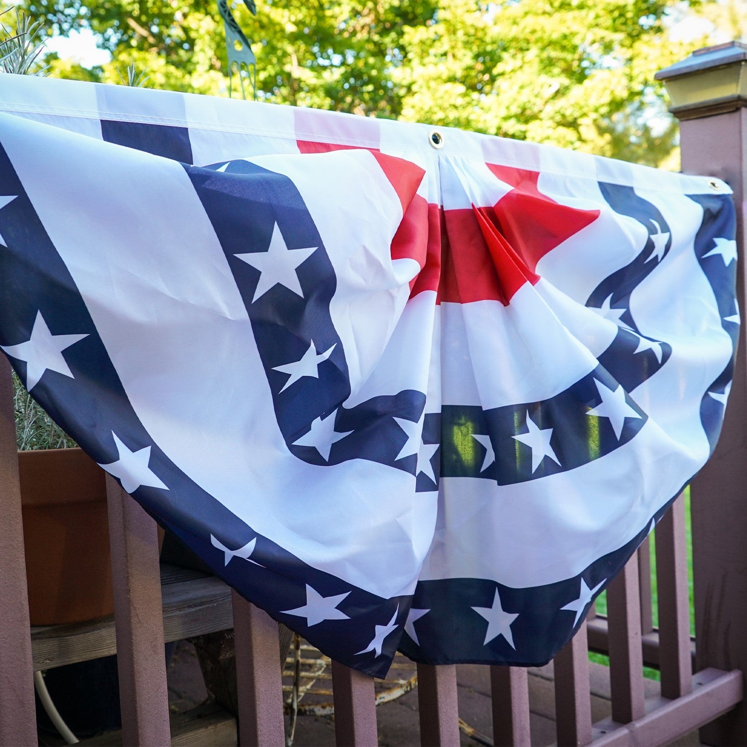 Blue Stripe Printed Bunting, featuring pleated half-circle design with brass grommets, displayed outdoors, ideal for patriotic decorations.