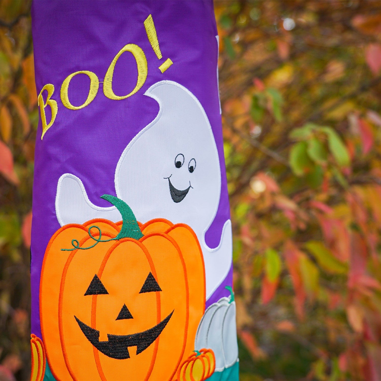 BOO! Halloween 40'' windsock featuring a playful ghost design with colorful tails flapping in the breeze, perfect for outdoor Halloween decoration.