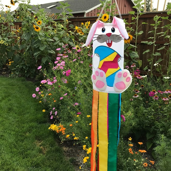 Bunny 3D Windsock in a festive garden setting, featuring vibrant colors and detailed embroidery, designed for seasonal decorations.