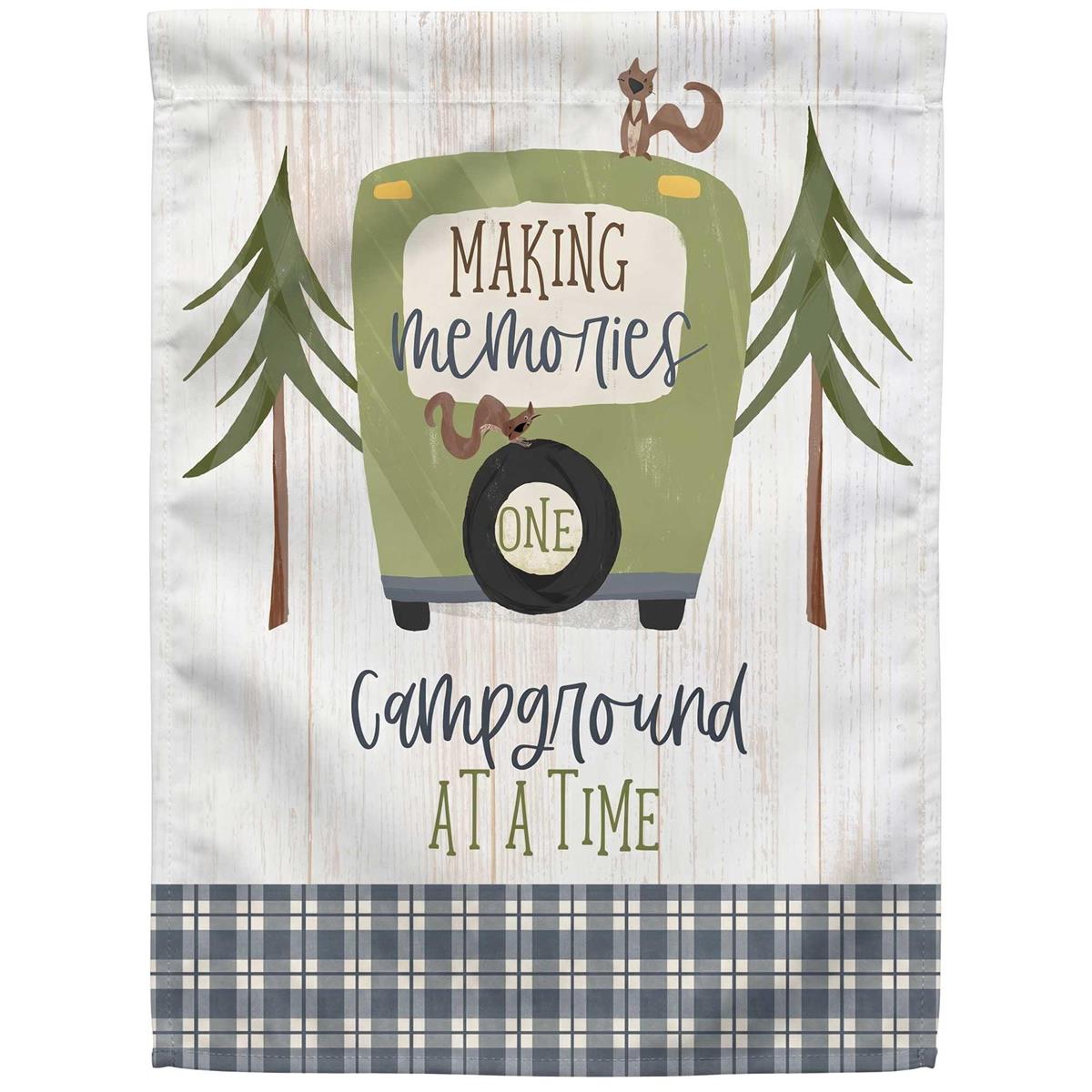 Camper Making Memories garden flag with an outdoor camping design displayed in a garden setting, showcasing vibrant colors and a stained glass effect.