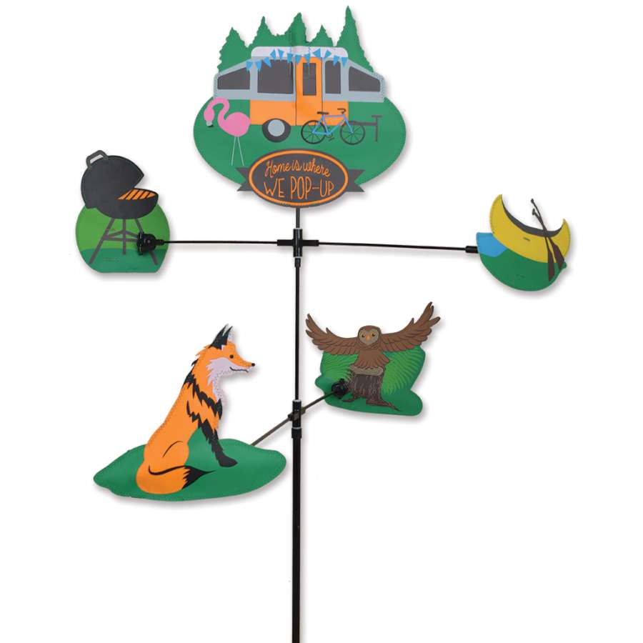 Carousel Spinner - Home Is Where We Pop Up in motion, displaying colorful shapes rotating beautifully in a garden setting under sunlight.