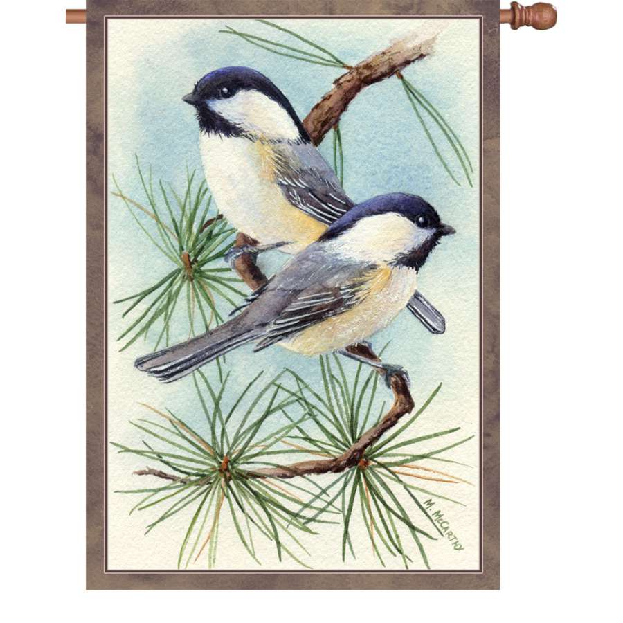 Illuminated 28 in. Chickadee Vignette house flag featuring a colorful chickadee surrounded by flowers, displayed outdoors.