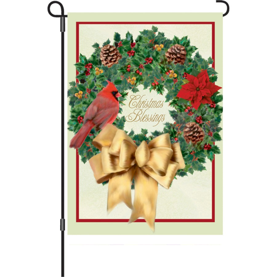 12 in. Christmas Blessings flag featuring festive design, displayed outdoors in a winter setting, spreading holiday cheer.