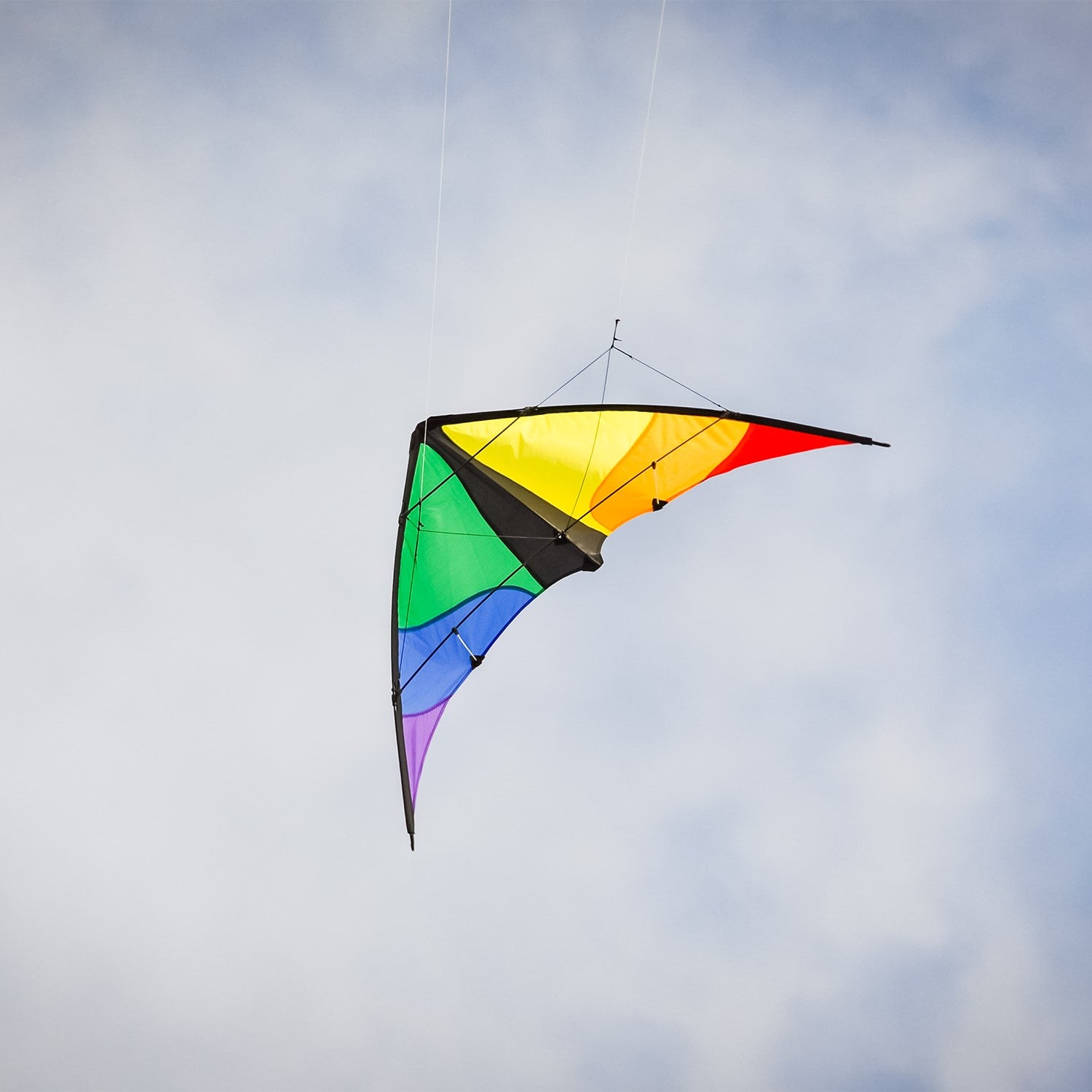 Colorwave 48" Sport Kite with a colorful rainbow design, displayed soaring in a clear blue sky, showcasing its vibrant colors and dynamic flying ability.