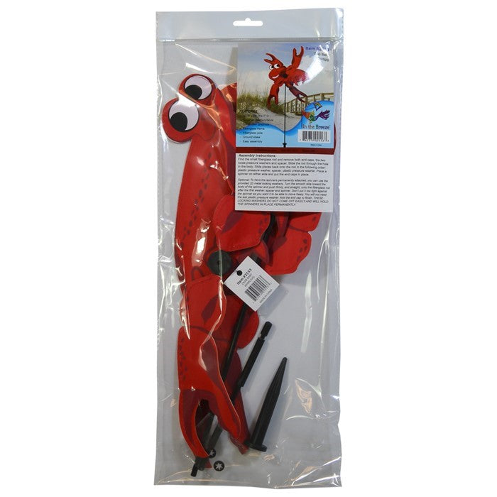Crab Baby Whirligig garden decoration with vibrant crab design featuring spinning claws, displayed outdoors in a garden setting.