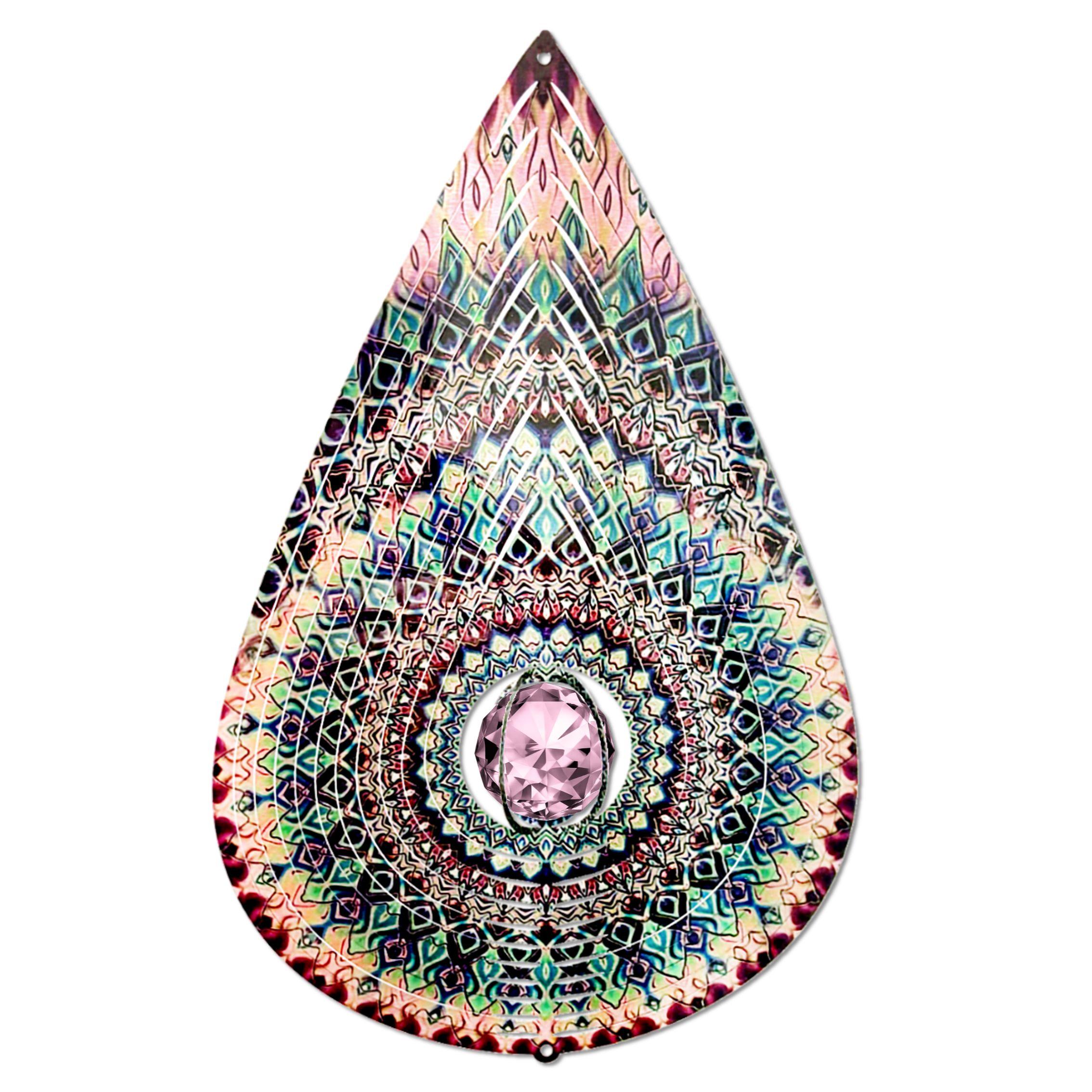 Crystal Rose Teardrop wind spinner with a shimmering crystal centerpiece, enhancing an outdoor garden or patio setting.