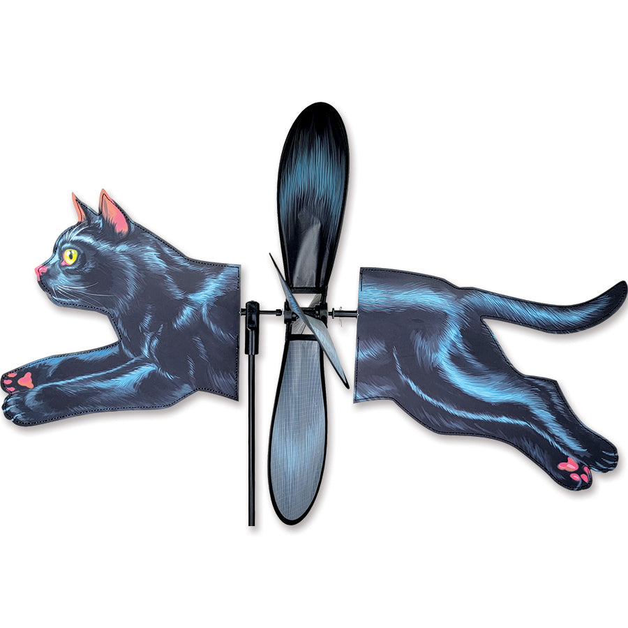 Deluxe Petite Spinner featuring a black cat design spinning in the outdoor garden, adorned with vibrant colors and captivating motion.