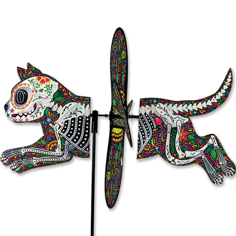 Deluxe Petite Spinner featuring Day of the Dead Cat, colorful design spinning outdoors in a vibrant garden setting.