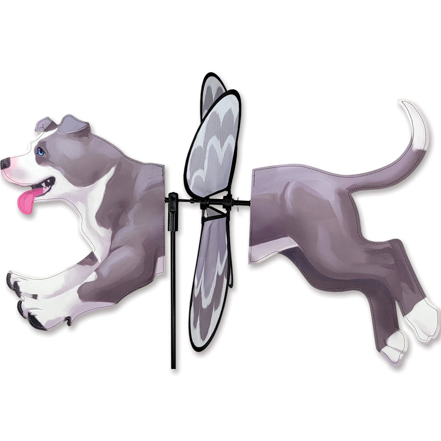Deluxe Petite Spinner featuring a colorful pit bull design spinning gracefully in a garden setting, showcasing outdoor charm and vibrancy.