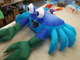 Compact blue and green bouncing crab kite accessory designed to hop and move in stronger breezes for playful beach and lawn displays.