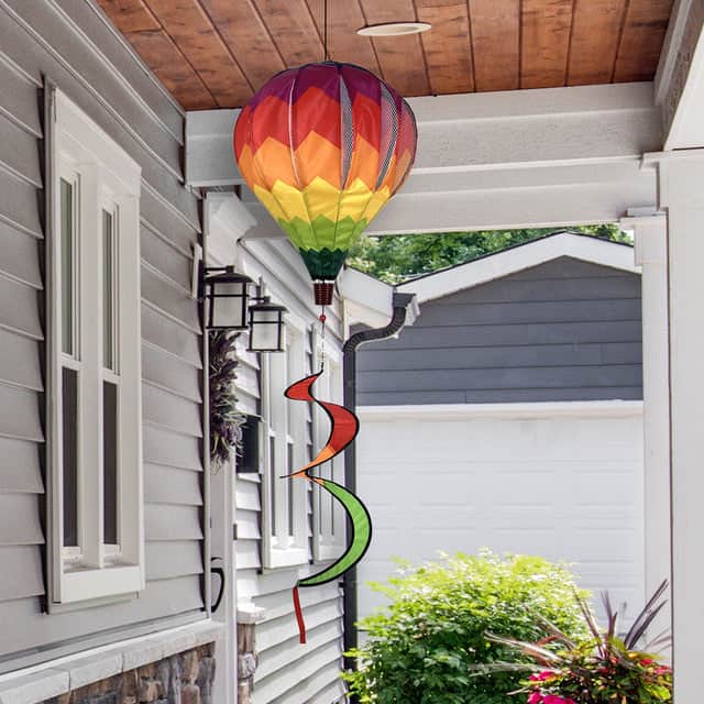 Rainbow chevron hot air balloon spinner with bright colors, weather-resistant polyester, and swirling tail for bold and cheerful outdoor décor.