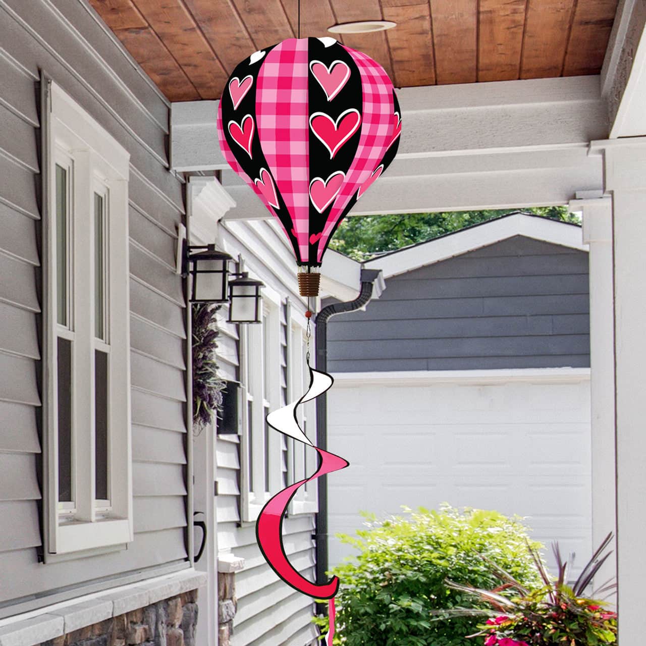Valentine’s hot air balloon spinner with heart patterns, durable polyester, and romantic spinning design for festive garden or porch decoration.