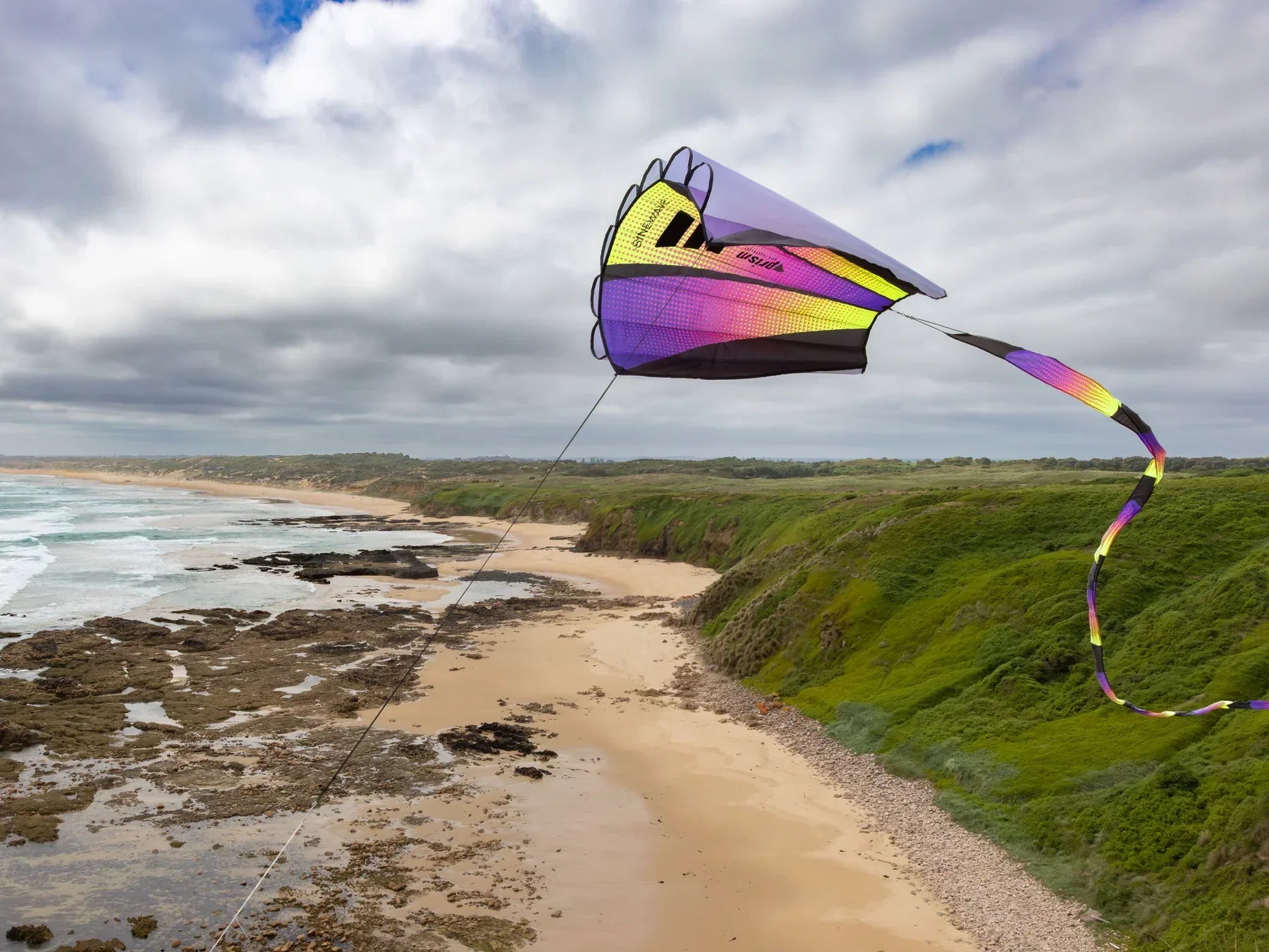 Sinewave kite with colorful parafoil design, smooth wave-like motion, and detachable tail—durable, frameless outdoor fun for flyers of all skill levels.