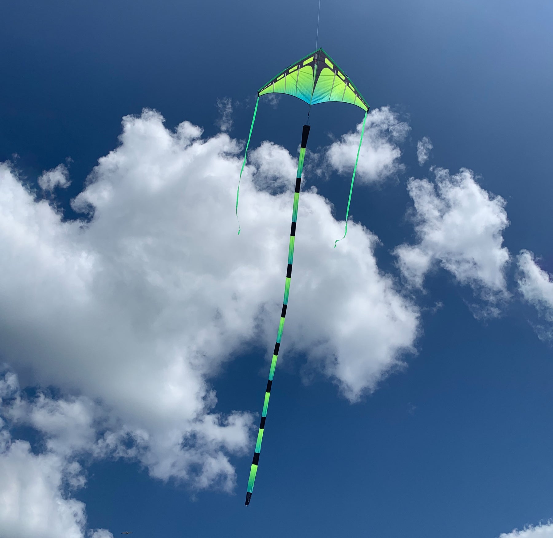 Prism Aurora tube tail with geometric gradient design, inflating tubular construction, and swivel clip for dynamic, flowing kite displays.