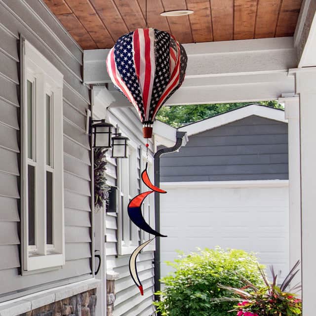USA-themed hot air balloon spinner with stars and stripes, durable polyester design, and breezy motion for festive patriotic outdoor garden décor.