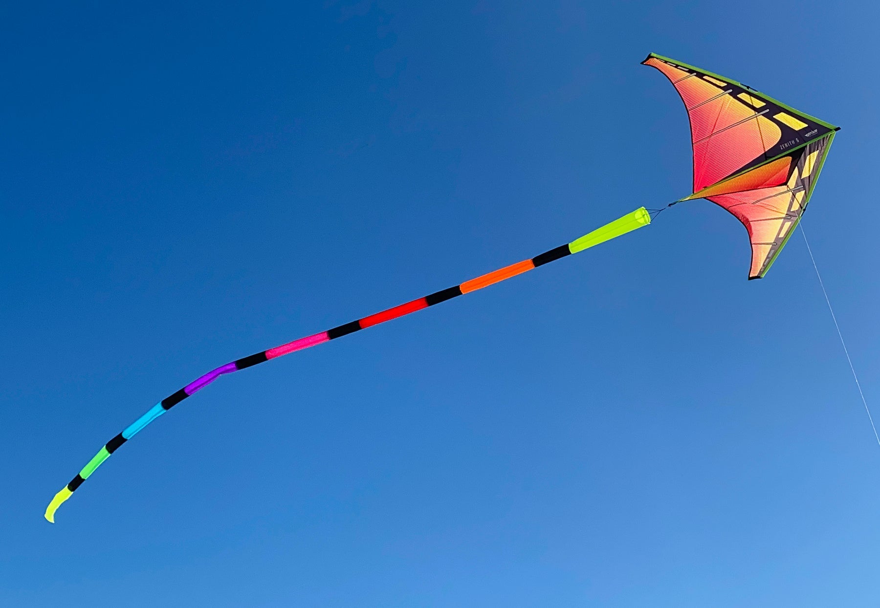 Spectrum tube tail with rainbow gradient, inflating airflow construction, and swivel clip attachment for vibrant, motion-filled kite flying.